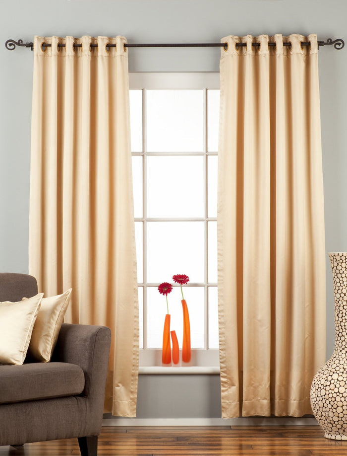 Golden sari grommet top curtains hung at a window