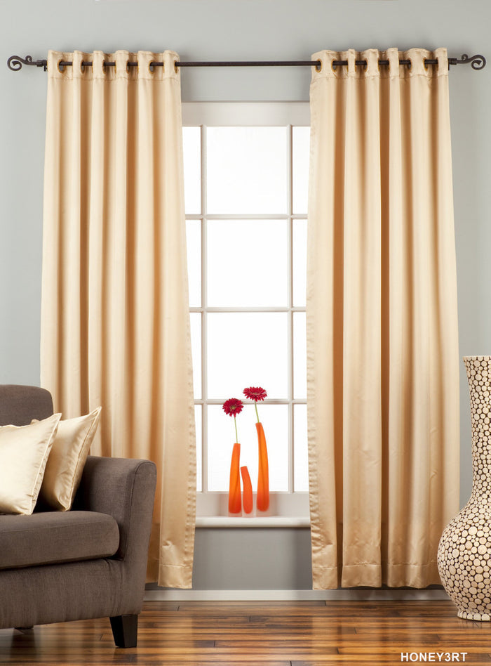 Golden sari grommet top curtains hung at a window