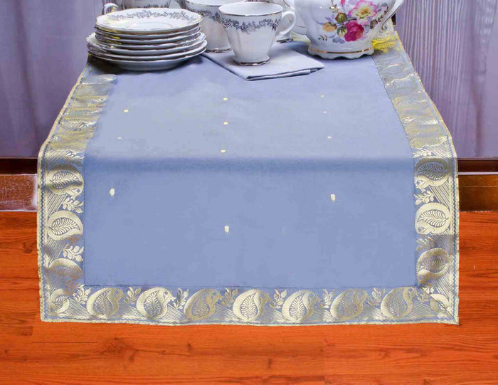 Gray silk table runner running down a dining table