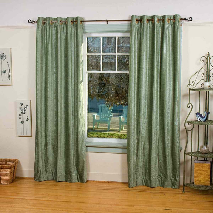 Olive green velvet grommet top curtains hung at a window