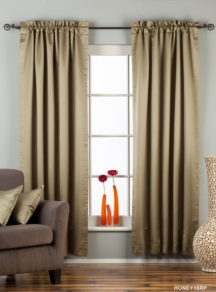 Olive green sari rod pocket curtains hung at a window
