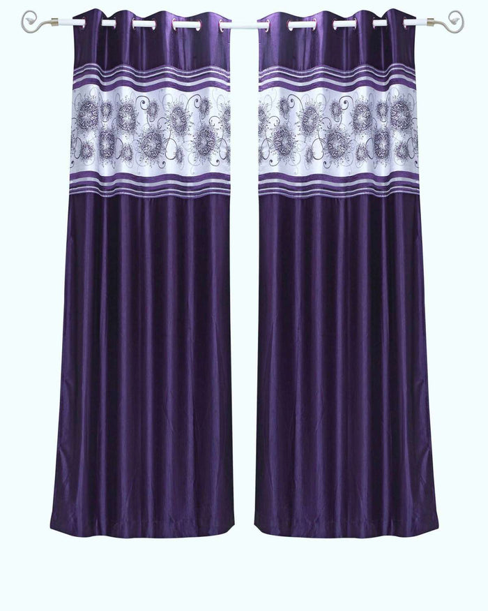 Purple sari grommet top curtains hung at a window