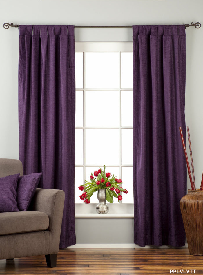 Purple velvet tab top curtains hung at a window