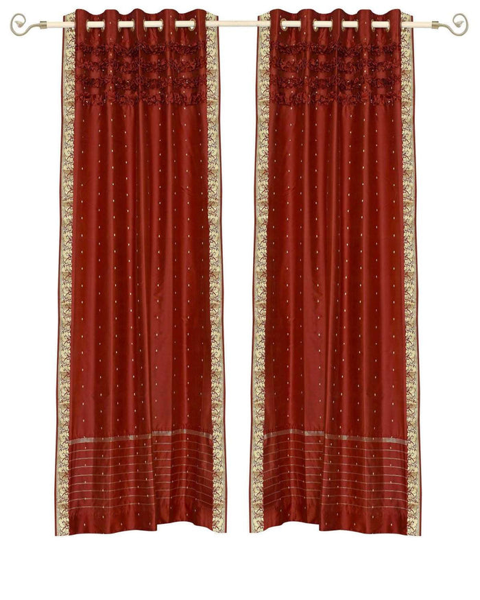Rust sari grommet top curtains hung at a window