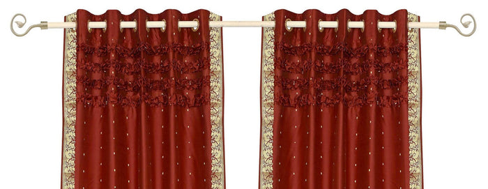 Rust sari grommet top curtains hung at a window