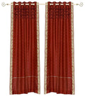 Rust sari grommet top curtains hung at a window