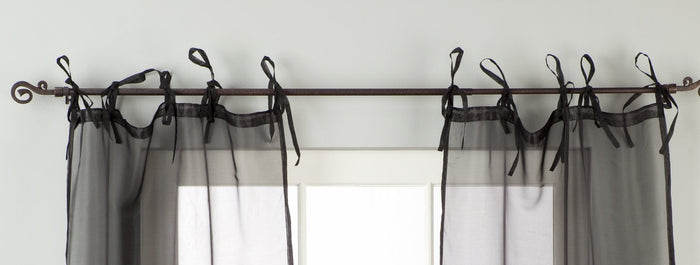 Sheer tissue tie top curtains hung at a window