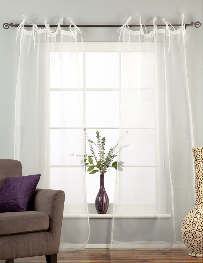 Sheer tissue tie top curtains hung at a window