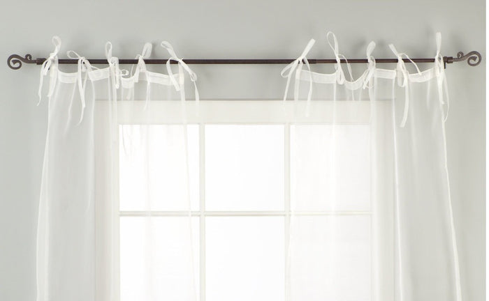 Sheer tissue tie top curtains hung at a window