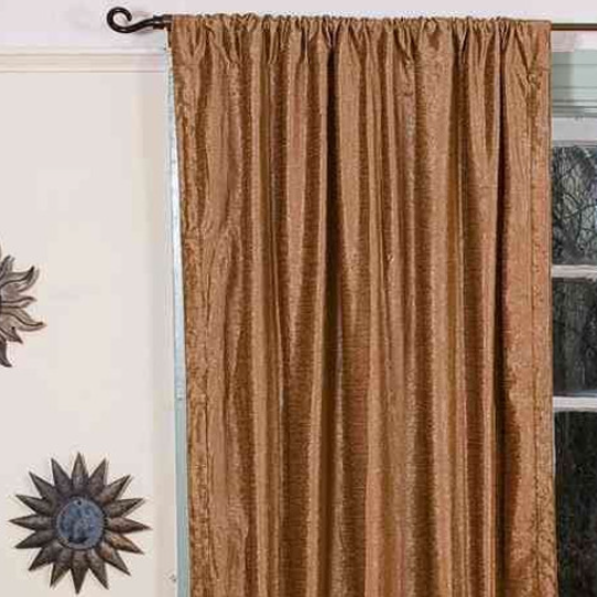 Taupe velvet rod pocket curtains hung at a window