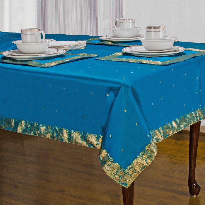 Turquoise sari tablecloth laid on a dining table