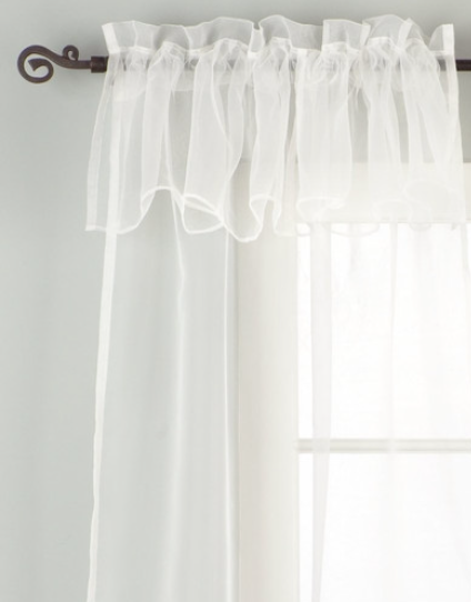 White sheer tissue rod pocket curtains hung at a window