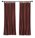 Wine velvet tab top curtains hung at a window