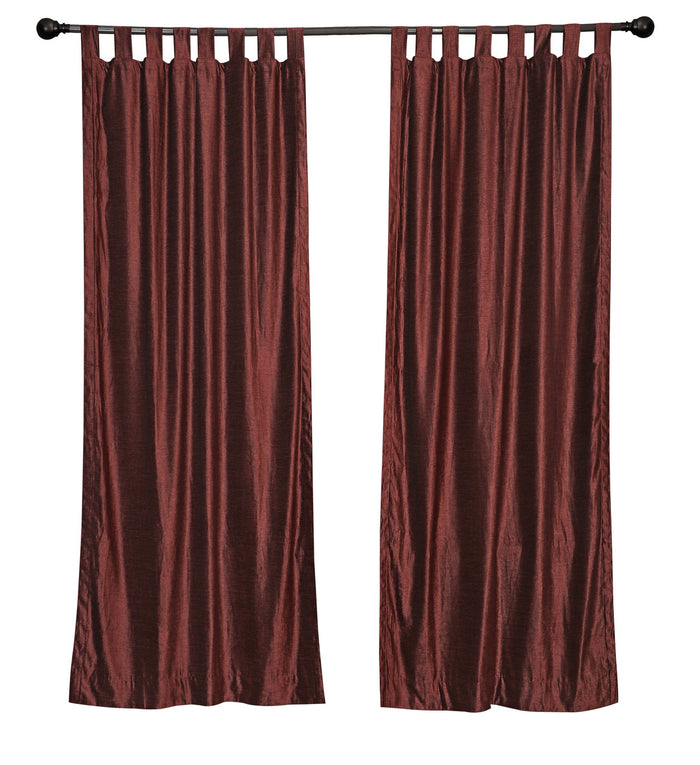 Wine velvet tab top curtains hung at a window