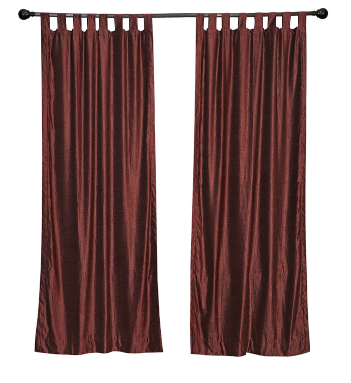 Wine velvet tab top curtains hung at a window