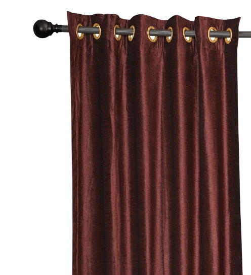 Wine velvet grommet top curtains hung at a window