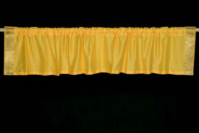Yellow sari valance mounted above a window